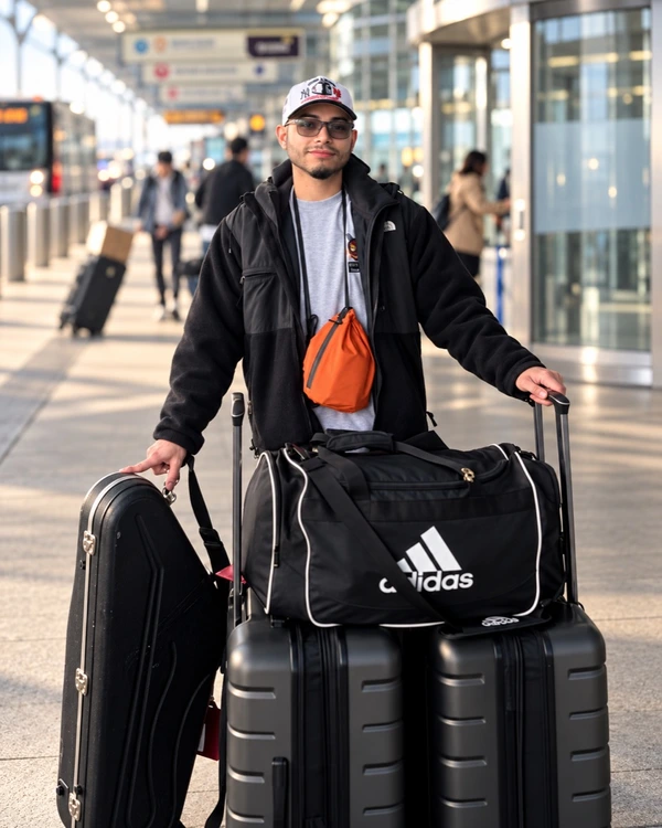 Chris at the airport with his saxophone case and luggage